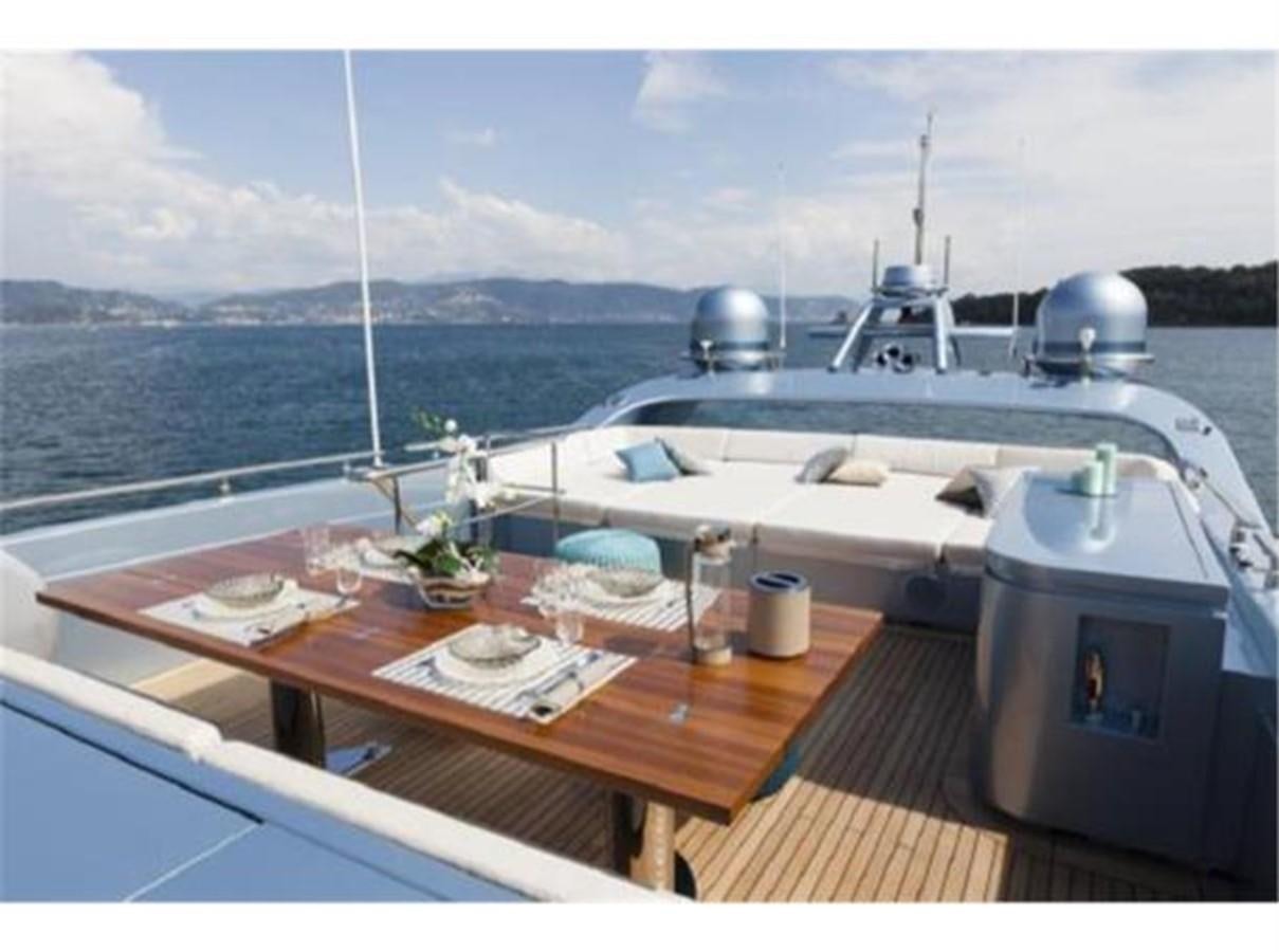 a table with plates and cups on it next to a boat aboard FRANCESCA Yacht for Sale