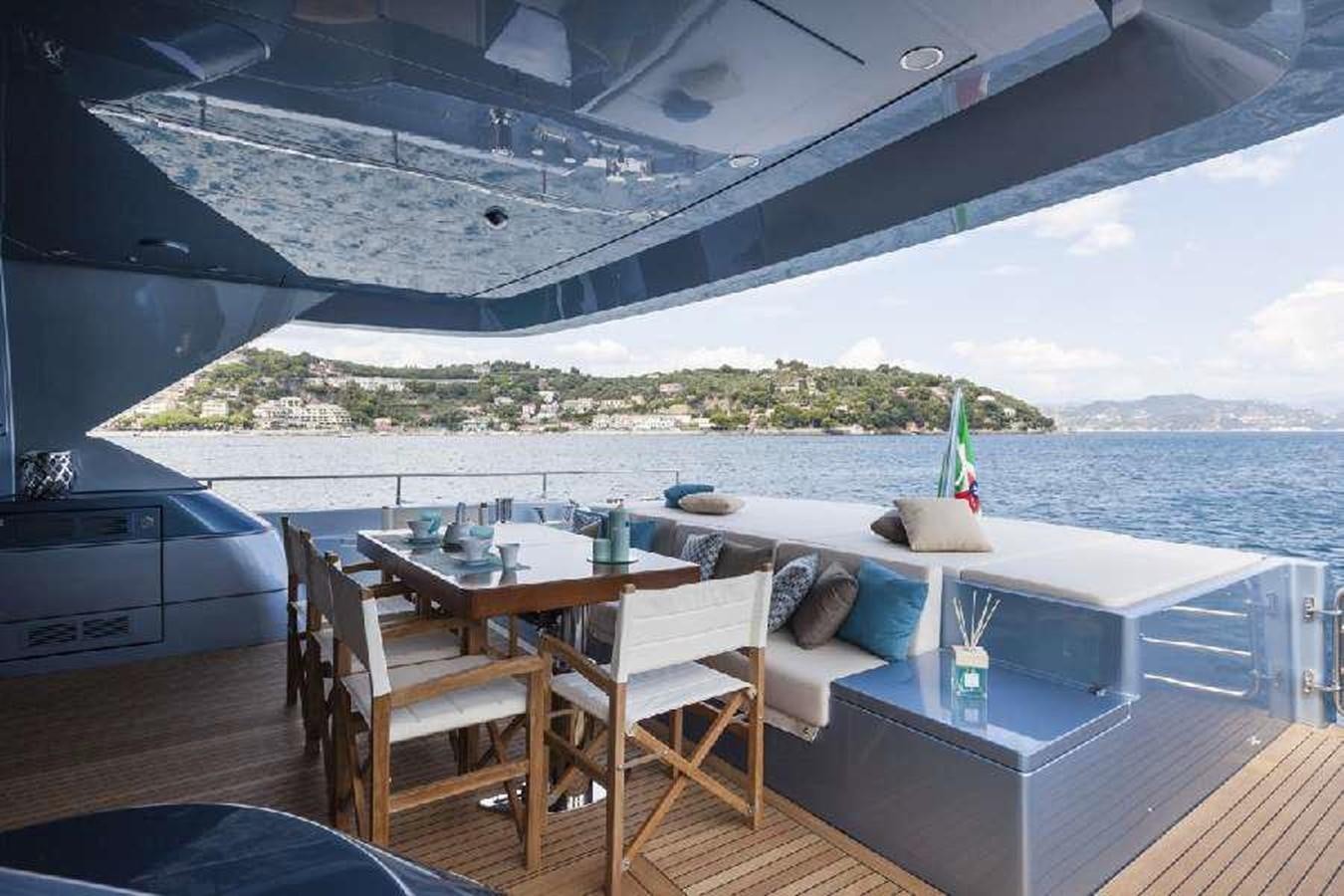 a deck with a table and chairs on it aboard FRANCESCA Yacht for Sale