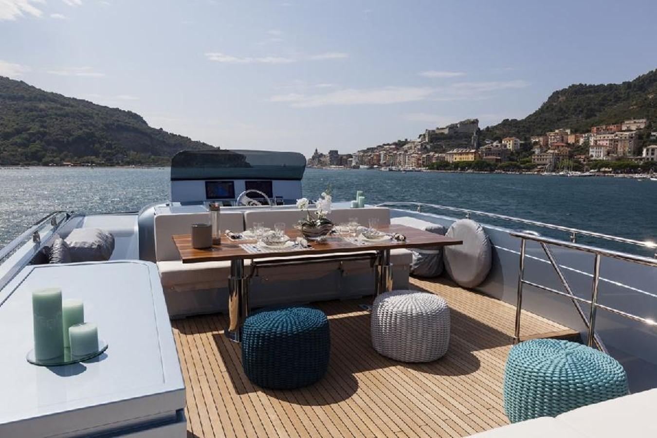 a table with chairs on it next to a body of water aboard FRANCESCA Yacht for Sale