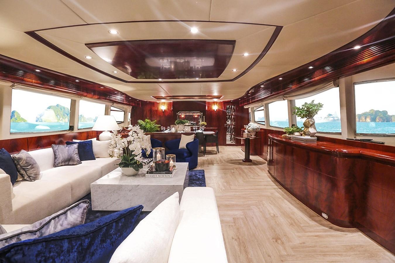 a living room with a large wood table and a large window aboard FOR YOUR EYES ONLY Yacht for Charter