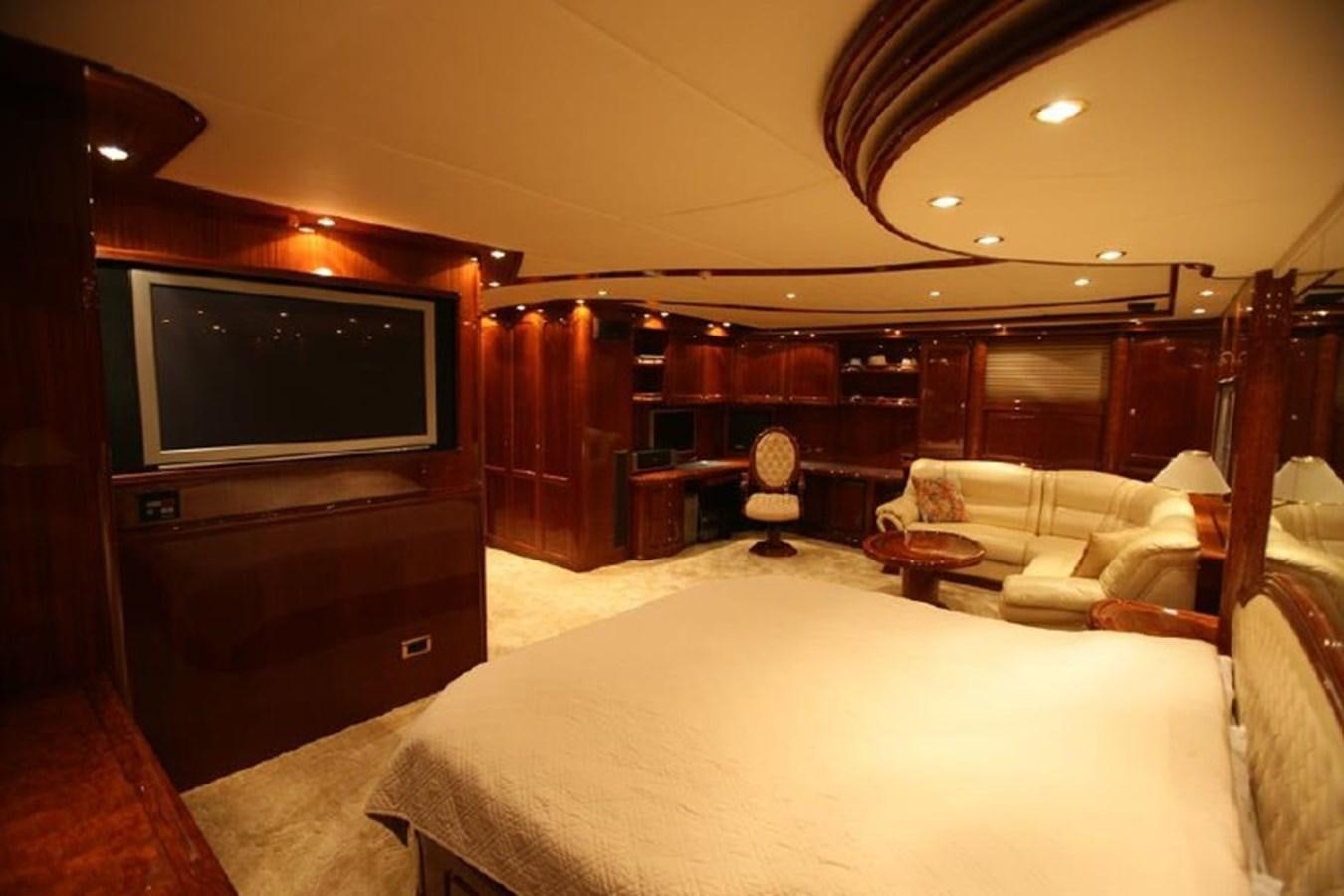 a bedroom with a bed and a television aboard OCEAN STAR Yacht for Sale