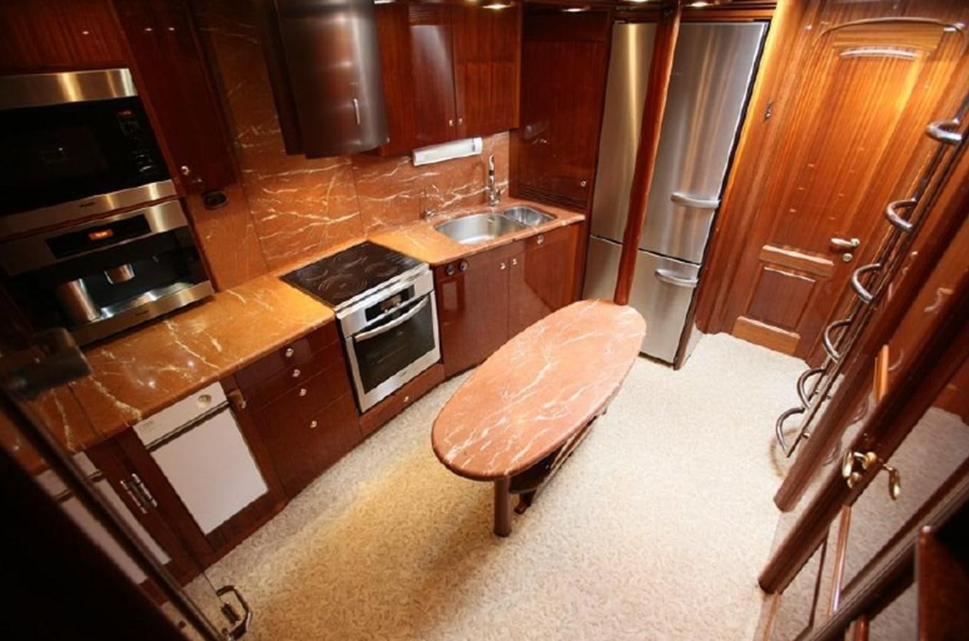a kitchen with wooden cabinets aboard OCEAN STAR Yacht for Sale