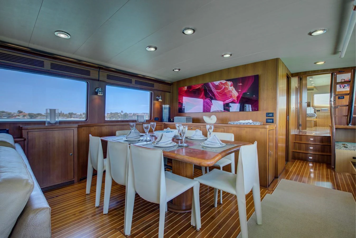 a dining room with a table and chairs aboard EXPLORER 97E-CB Yacht for Sale