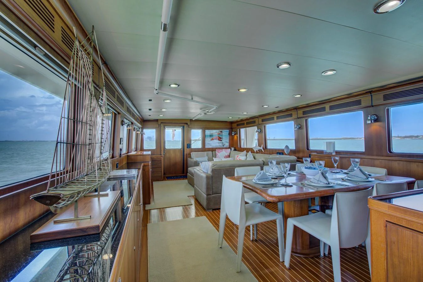 a large room with a table and chairs aboard EXPLORER 97E-CB Yacht for Sale