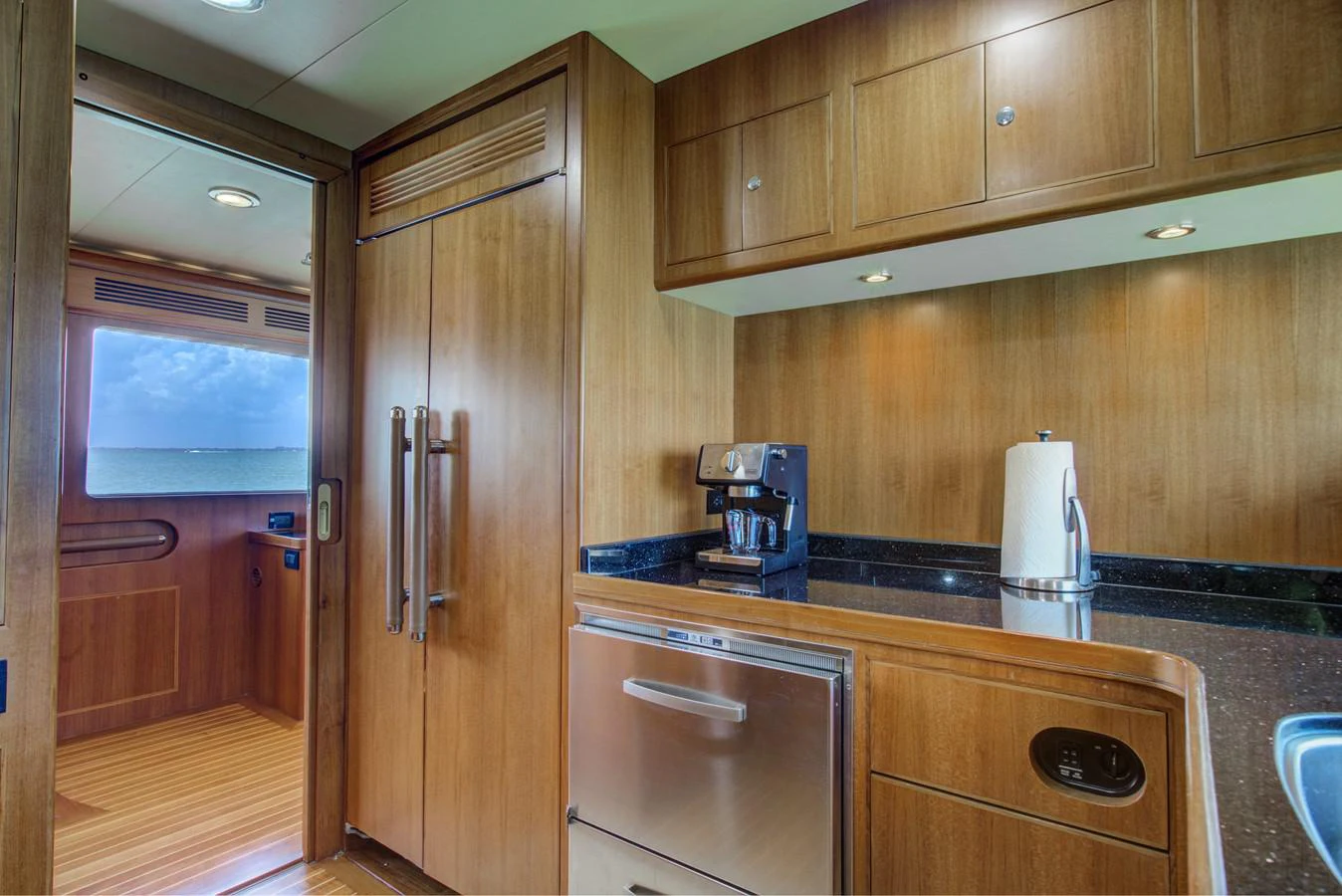 a kitchen with wooden cabinets aboard EXPLORER 97E-CB Yacht for Sale