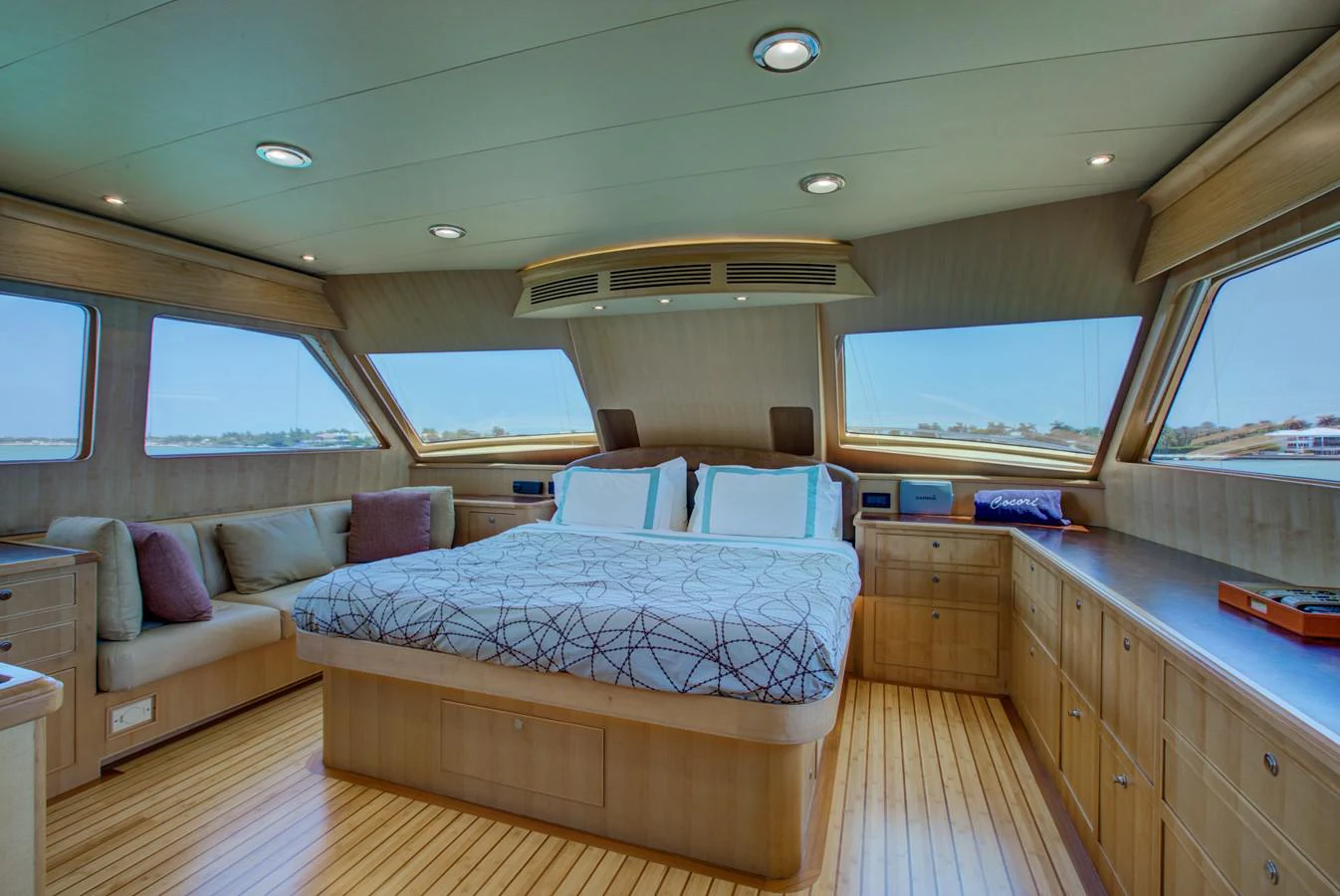 a bedroom with a bed and a couch aboard EXPLORER 97E-CB Yacht for Sale