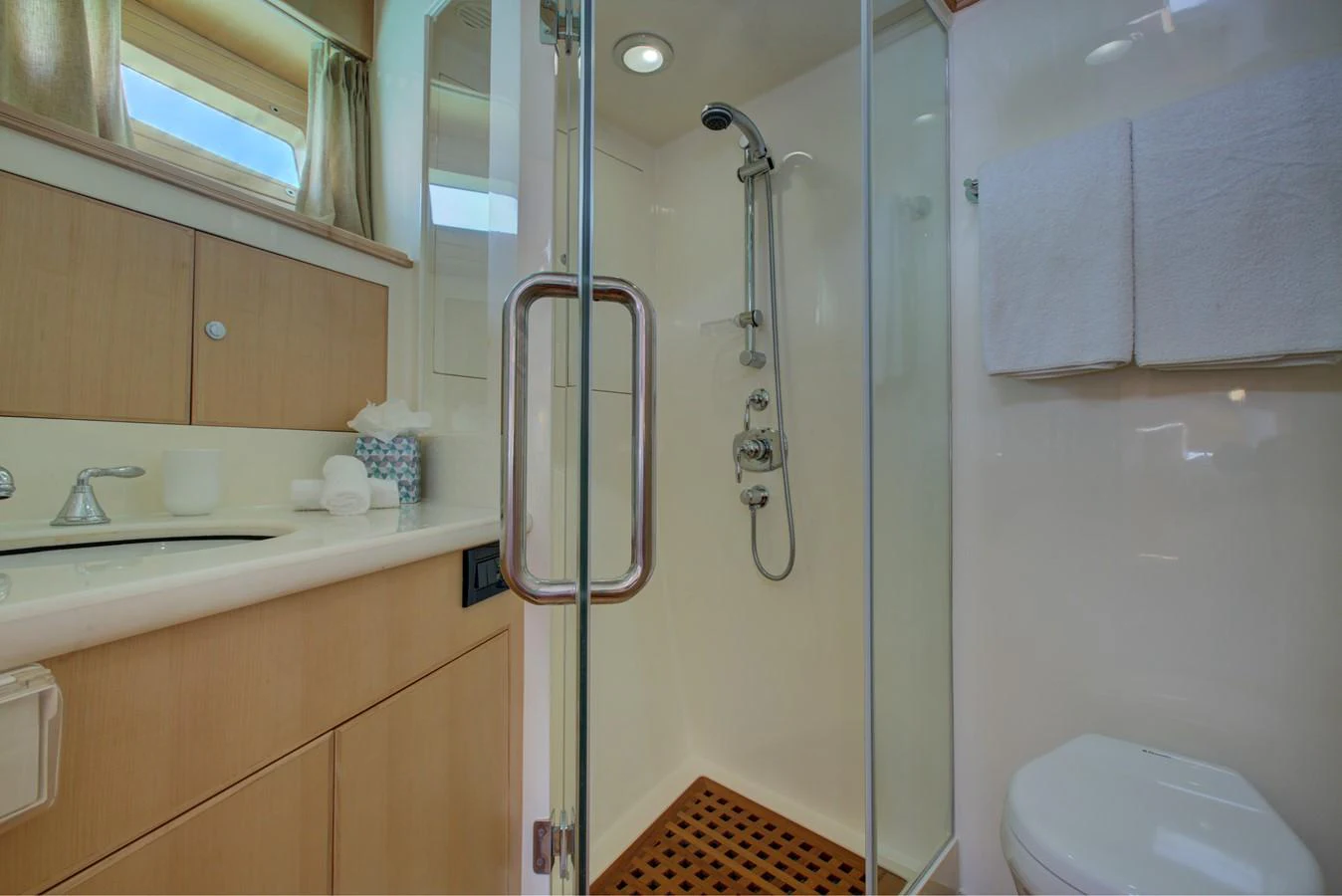 a bathroom with a shower and toilet aboard EXPLORER 97E-CB Yacht for Sale