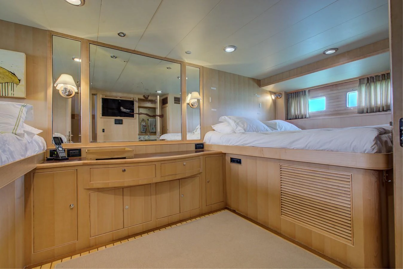 a room with a bed and a mirror aboard EXPLORER 97E-CB Yacht for Sale