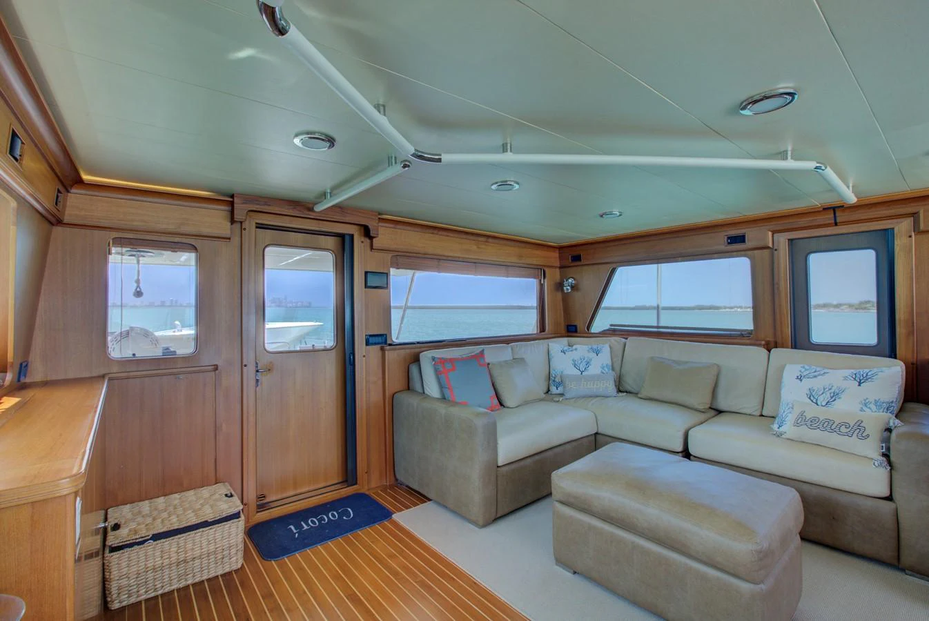 a living room with a couch and a window aboard EXPLORER 97E-CB Yacht for Sale