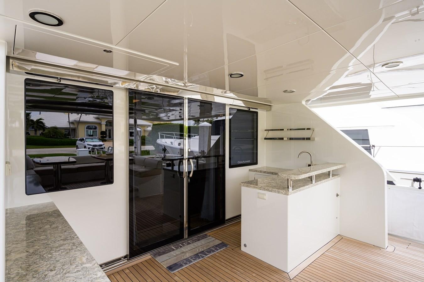 a modern kitchen with glass doors aboard ZEPHYR Yacht for Sale