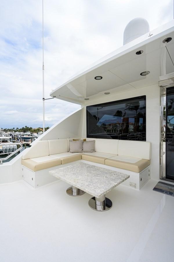 a white lounge chair on a white floor next to a window aboard ZEPHYR Yacht for Sale