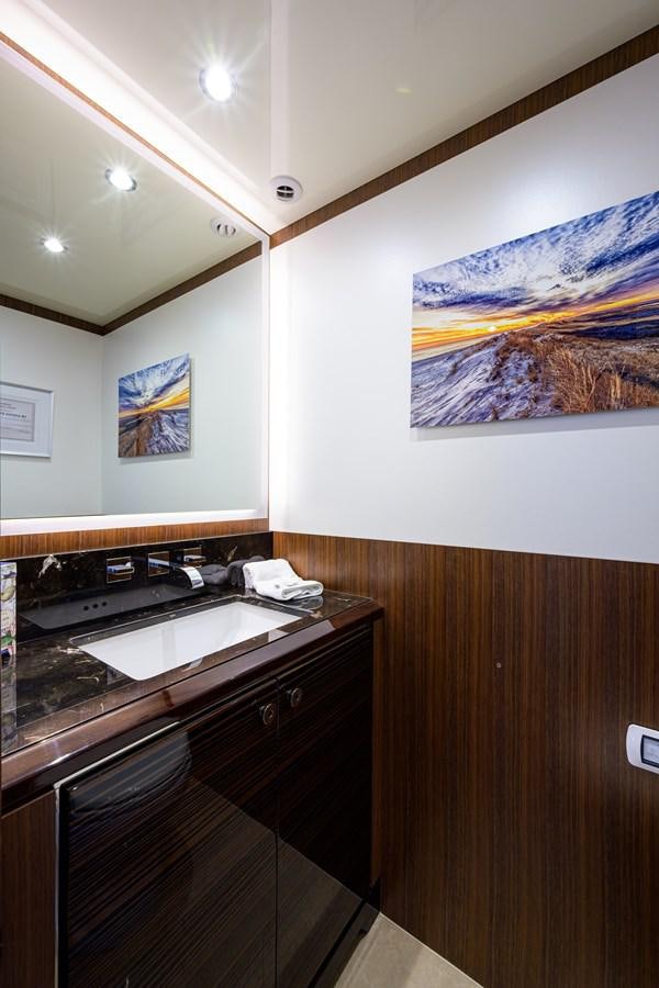 a kitchen with a painting on the wall aboard ZEPHYR Yacht for Sale