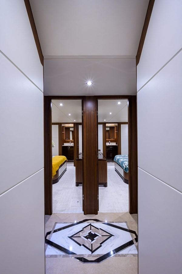 a hallway with a door and a bed aboard ZEPHYR Yacht for Sale