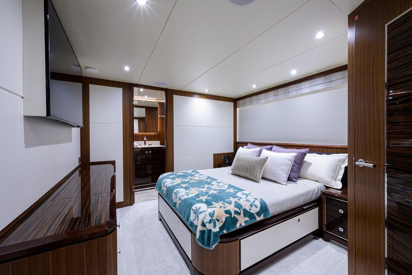 a bedroom with a bed and a closet aboard ZEPHYR Yacht for Sale