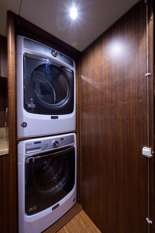 a washer and dryer in a wooden room aboard ZEPHYR Yacht for Sale