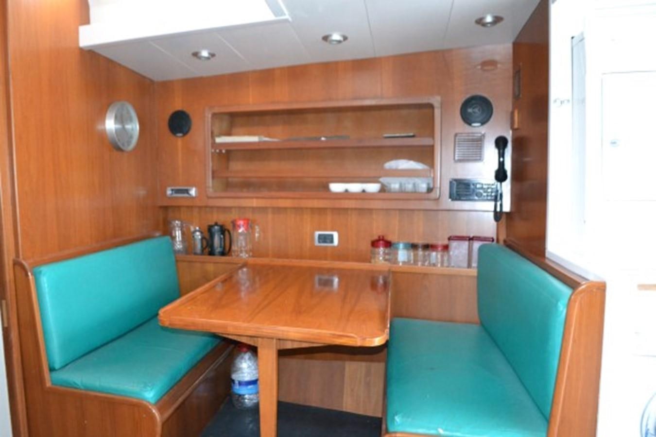 a room with a table and chairs aboard ADEVIYE Yacht for Sale