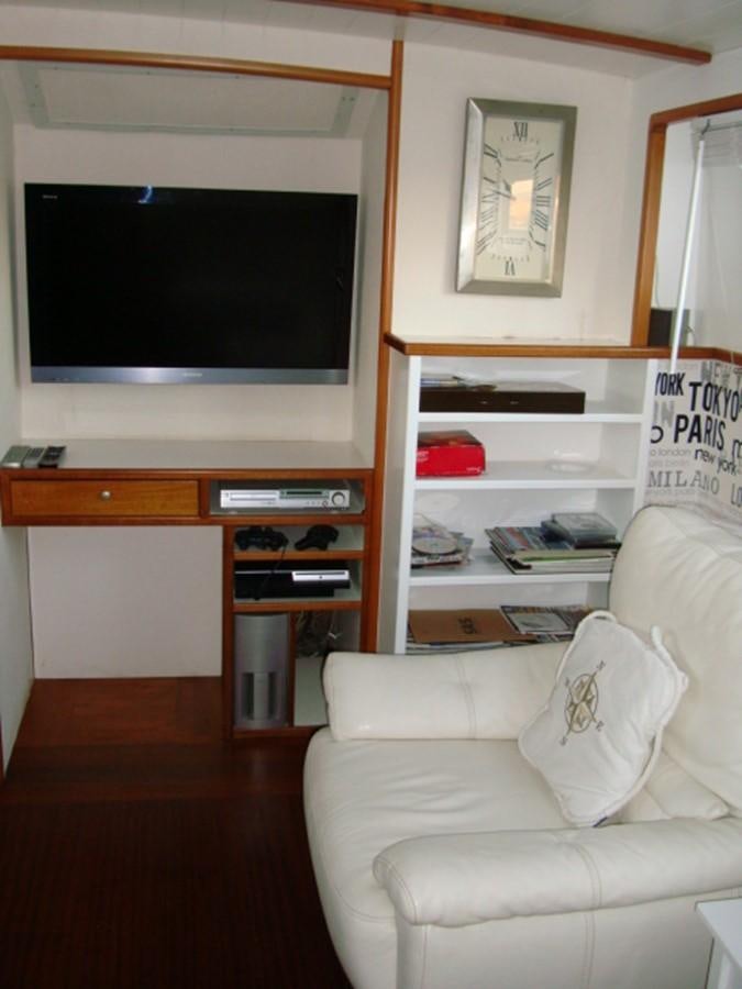 a living room with a white couch and a television aboard ADEVIYE Yacht for Sale