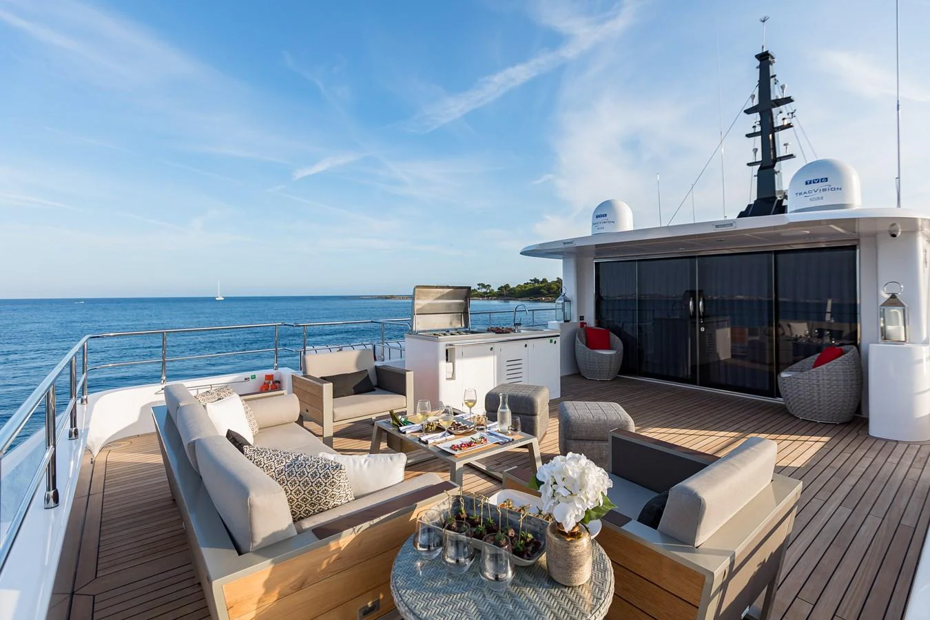 a deck with a large body of water and a large ship in the background aboard JEWEL Yacht for Sale