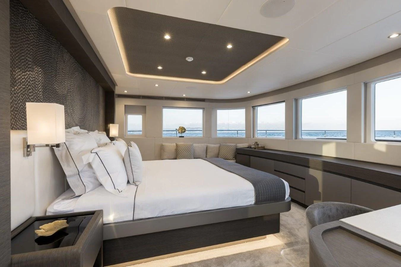 a bedroom with a bed and a large window aboard JEWEL Yacht for Sale