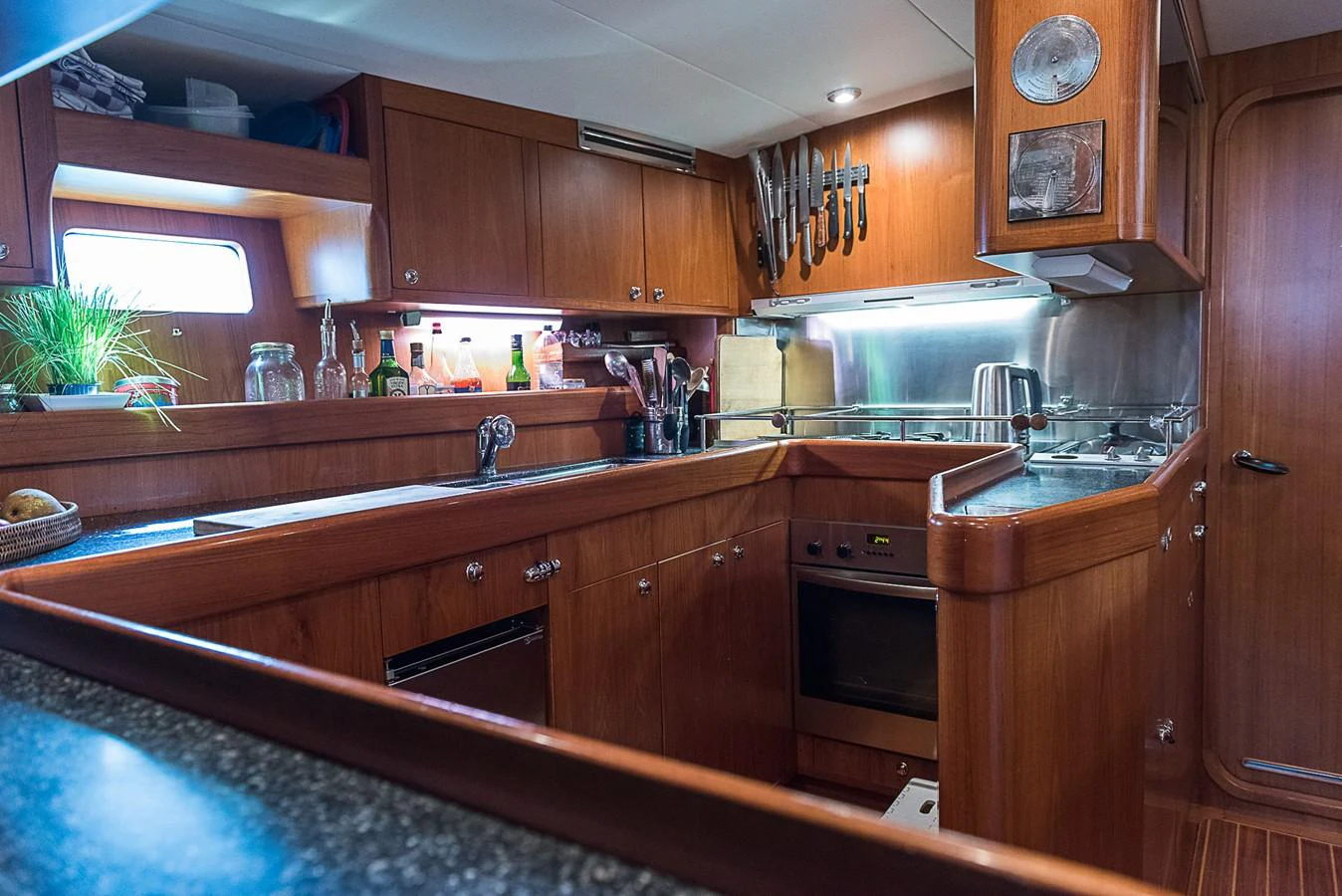 a kitchen with wooden cabinets aboard SINDONEMO Yacht for Sale