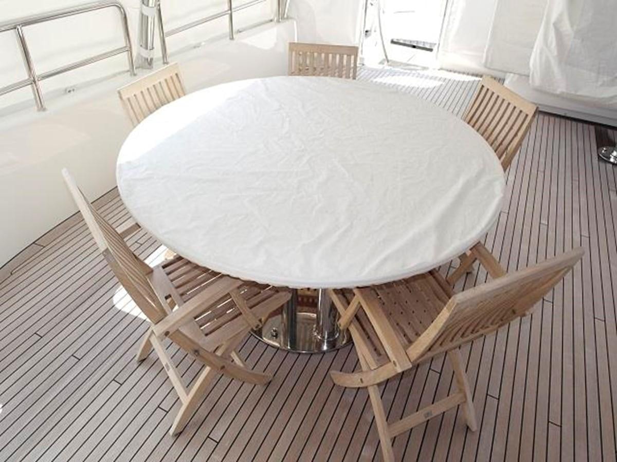 a table with chairs on it aboard BENETTI TRADITION 100 Yacht for Sale