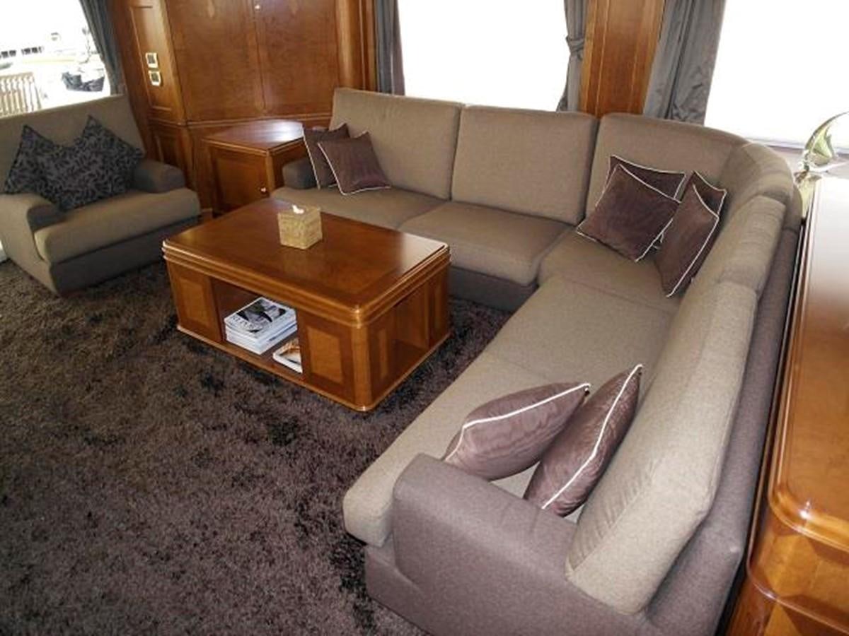 a living room with a couch and a coffee table aboard BENETTI TRADITION 100 Yacht for Sale