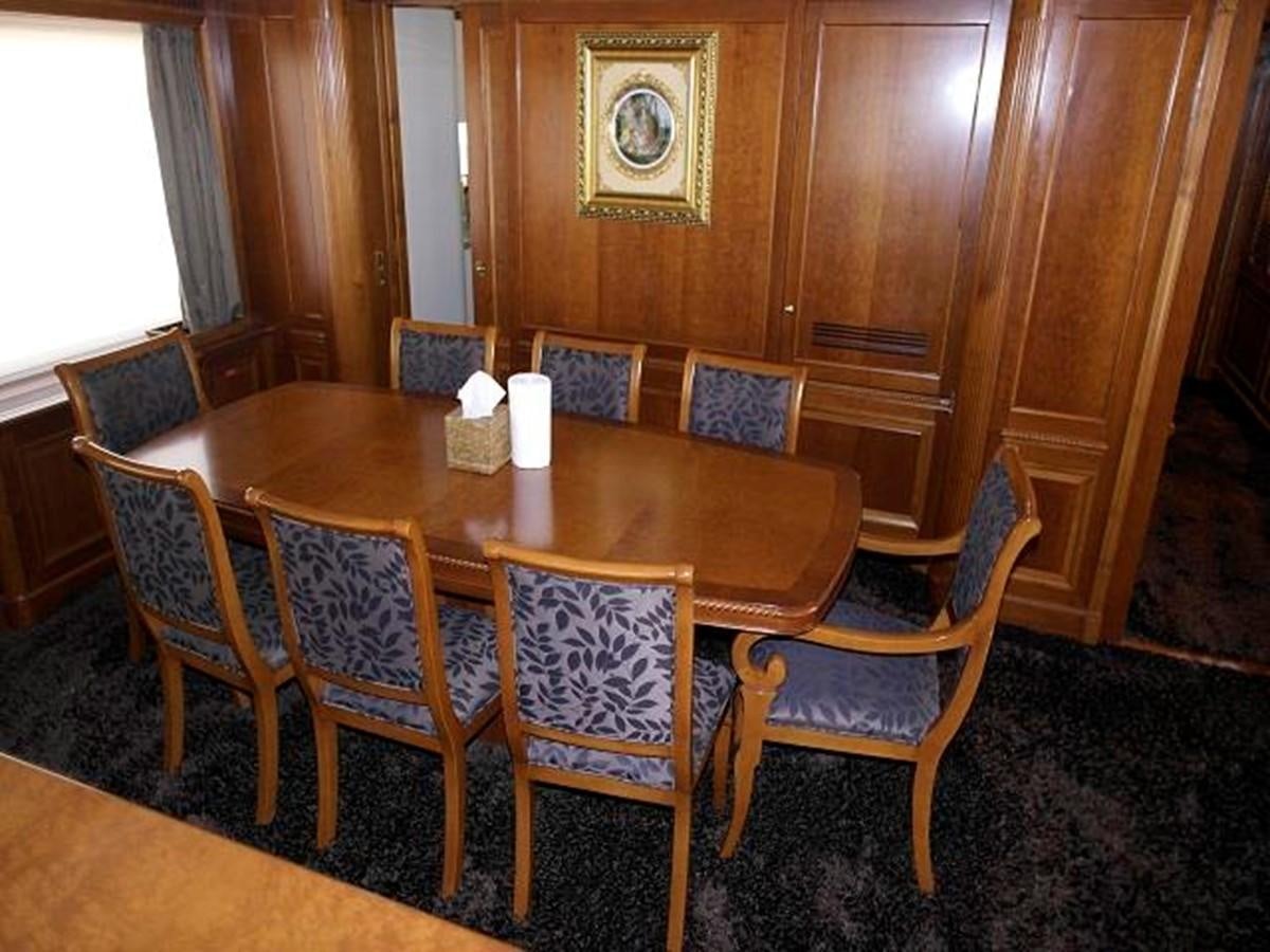 a dining table with chairs around it aboard BENETTI TRADITION 100 Yacht for Sale