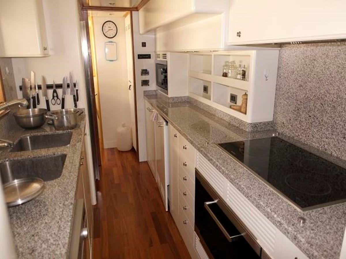 a kitchen with a sink and cabinets aboard BENETTI TRADITION 100 Yacht for Sale