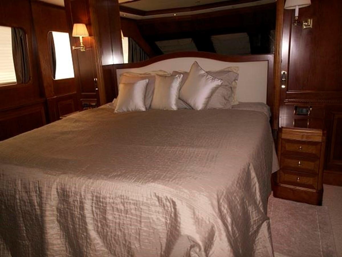 a bed with white sheets aboard BENETTI TRADITION 100 Yacht for Sale