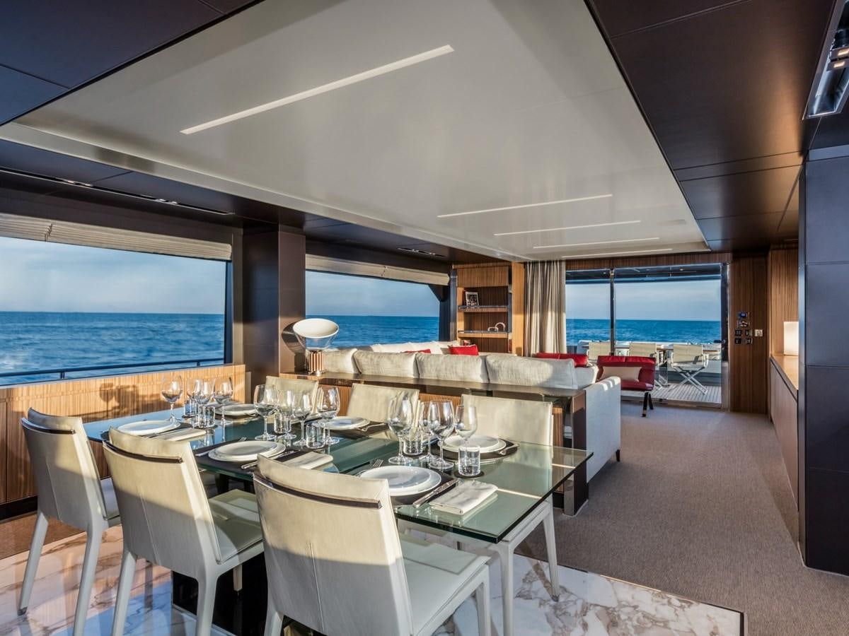 a room with tables and chairs aboard BESO Yacht for Sale