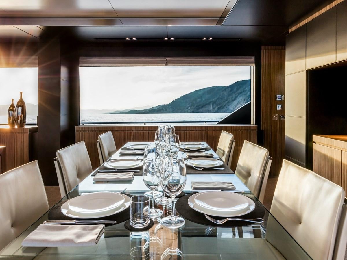 a dining table with plates and glasses aboard BESO Yacht for Sale