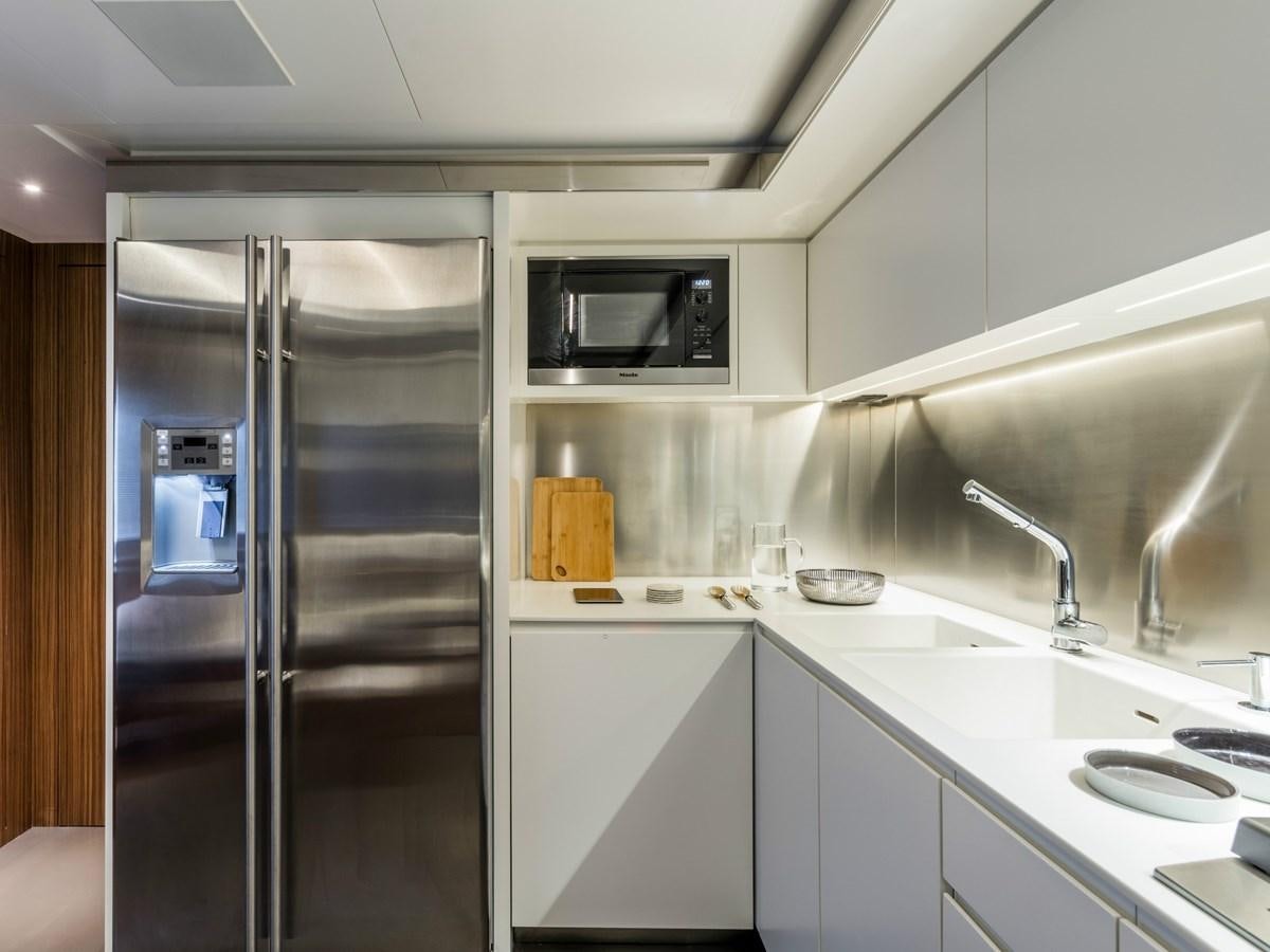 a kitchen with a glass door aboard BESO Yacht for Sale