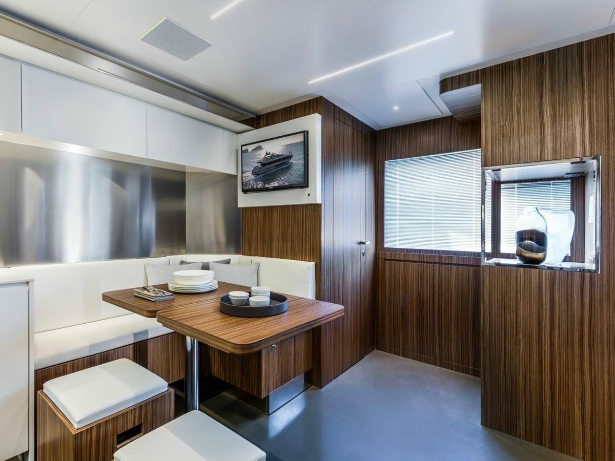 a room with a table and chairs aboard BESO Yacht for Sale