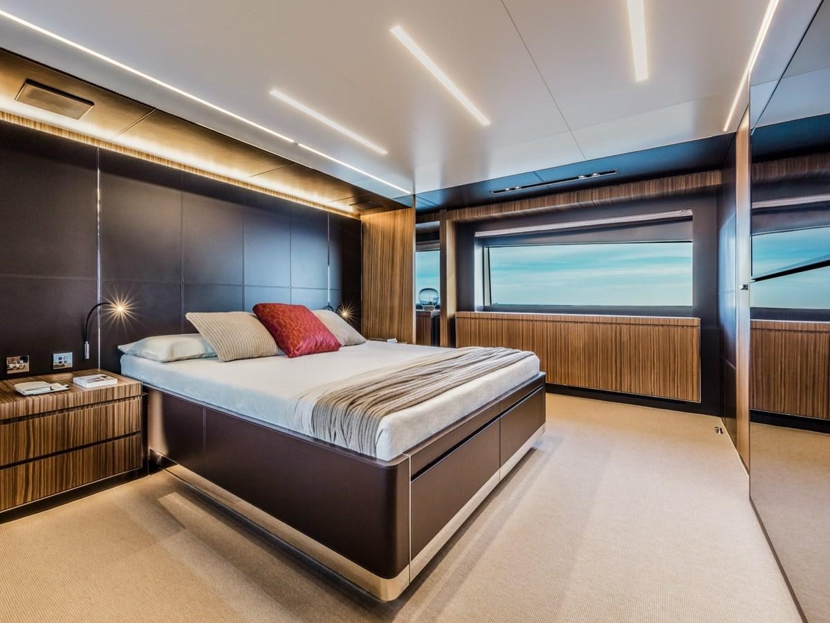 a large bedroom with a large bed aboard BESO Yacht for Sale