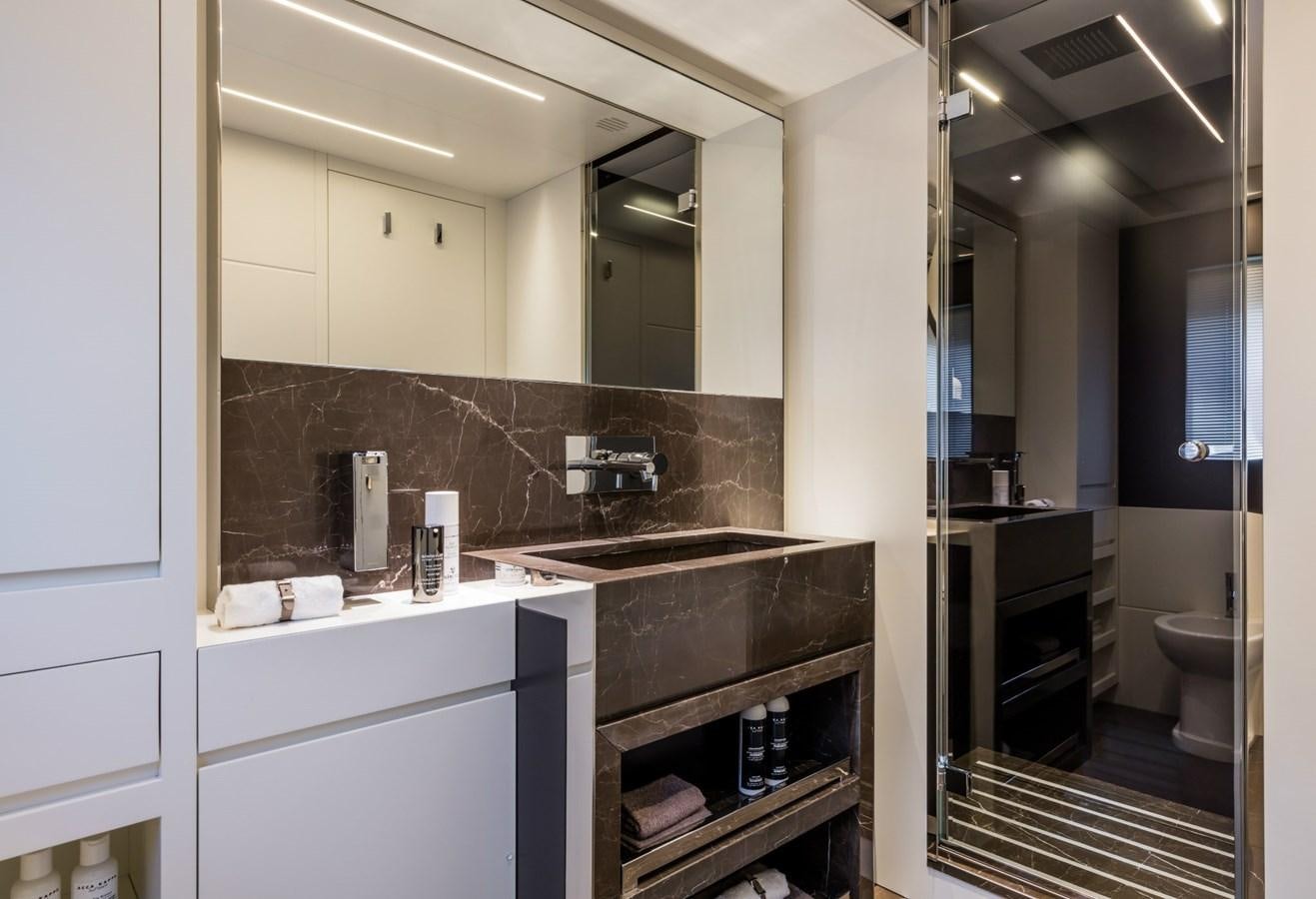 a bathroom with a large mirror aboard BESO Yacht for Sale