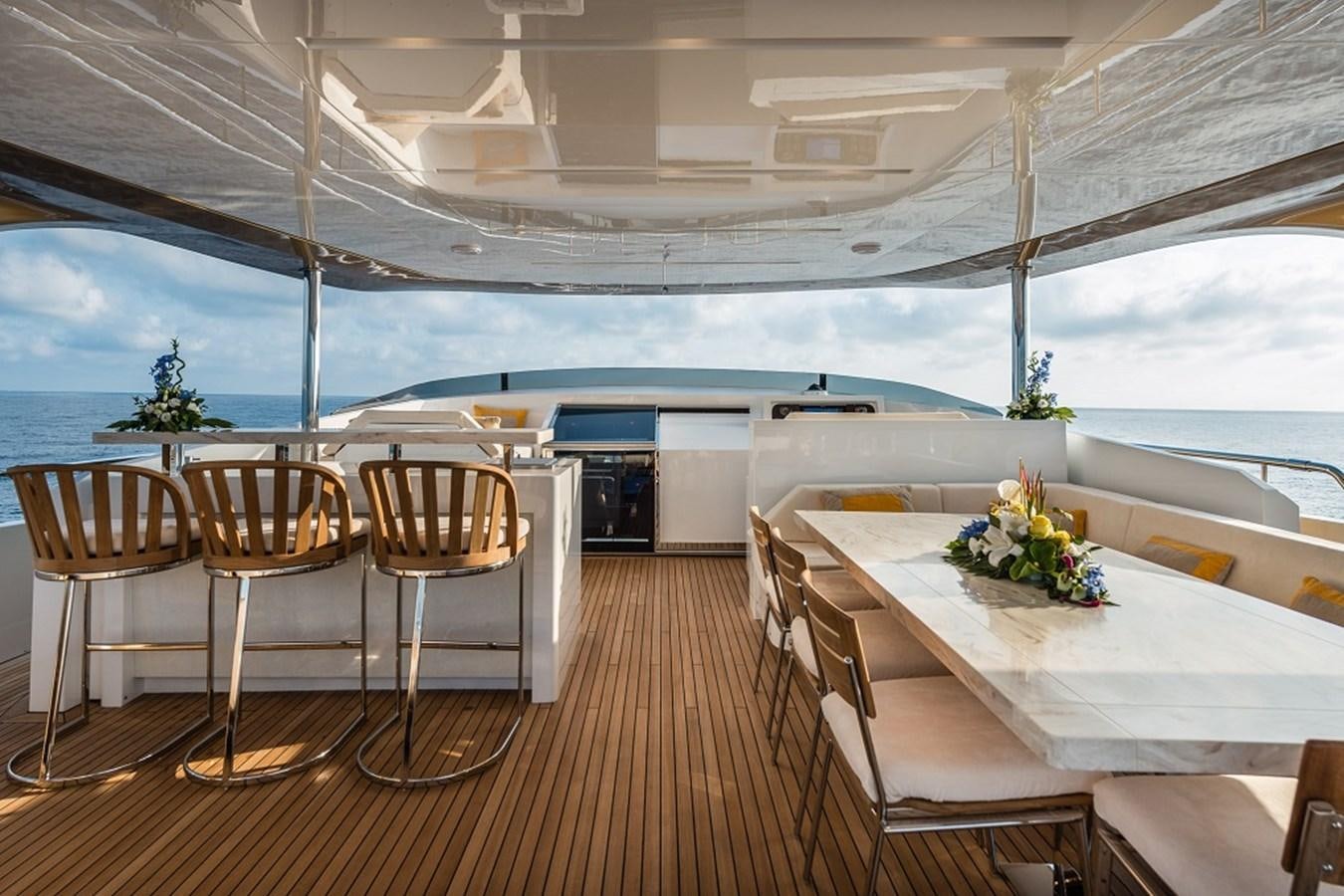 a room with tables and chairs aboard TABOO OF THE SEAS Yacht for Sale