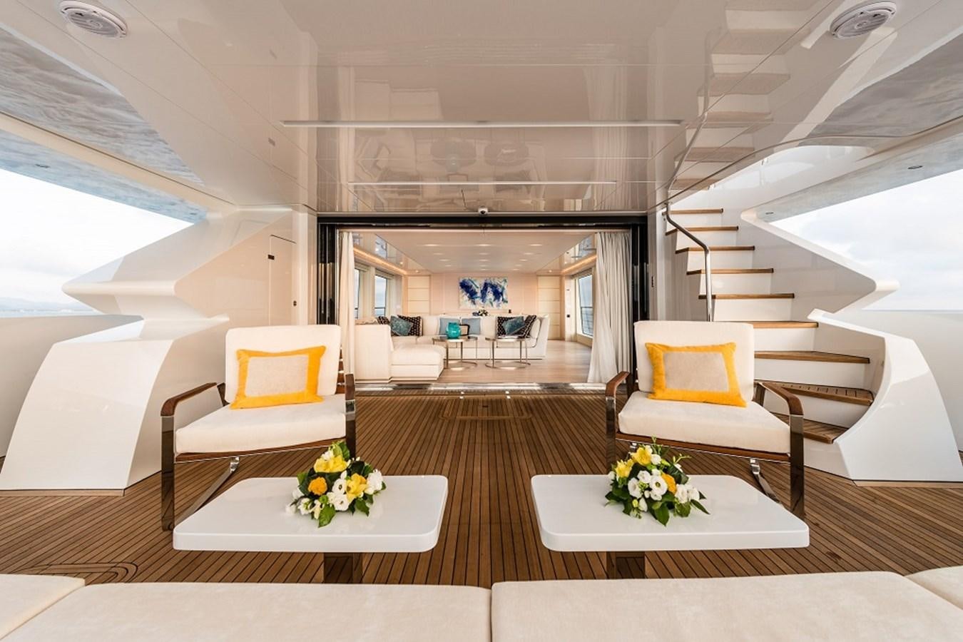 a room with a table chairs and a couch aboard TABOO OF THE SEAS Yacht for Sale