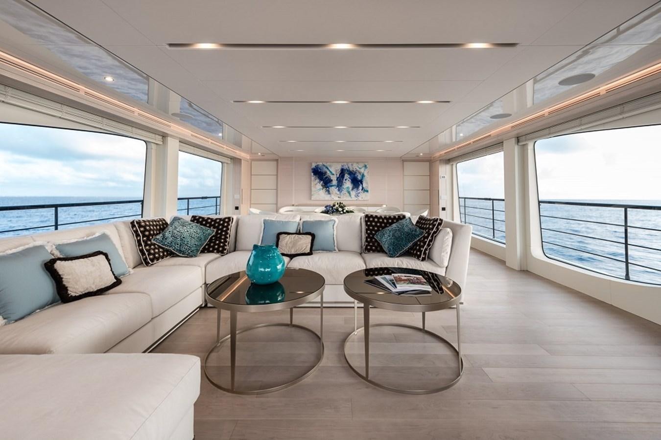 a living room with a large window aboard TABOO OF THE SEAS Yacht for Sale