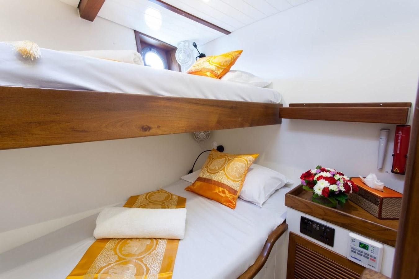 a bed with a tray of food aboard DALLINGHOO Yacht for Sale