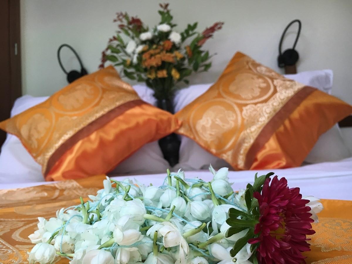 a table with a flower and pillows aboard DALLINGHOO Yacht for Sale