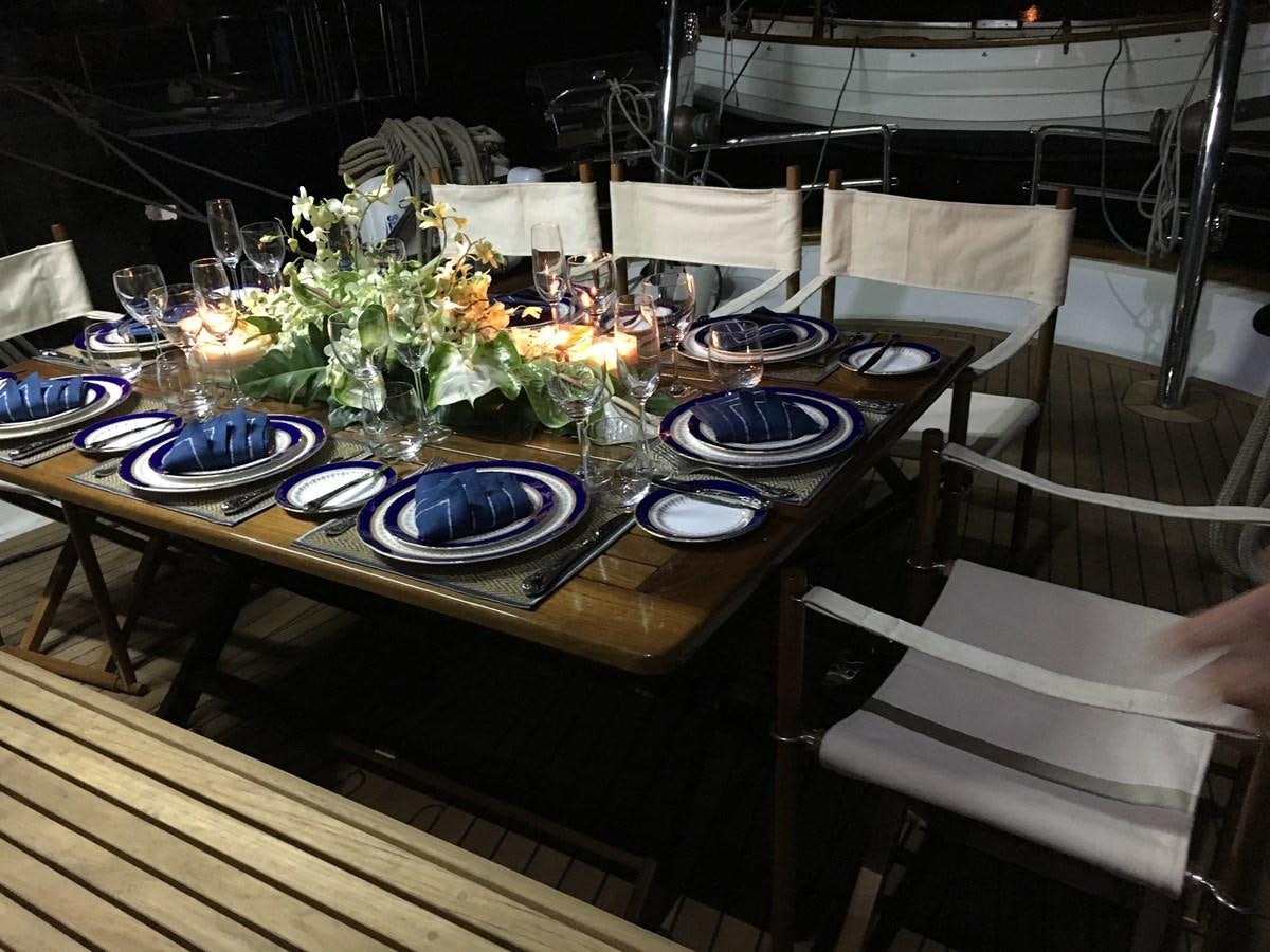 a table set with plates and glasses aboard DALLINGHOO Yacht for Sale