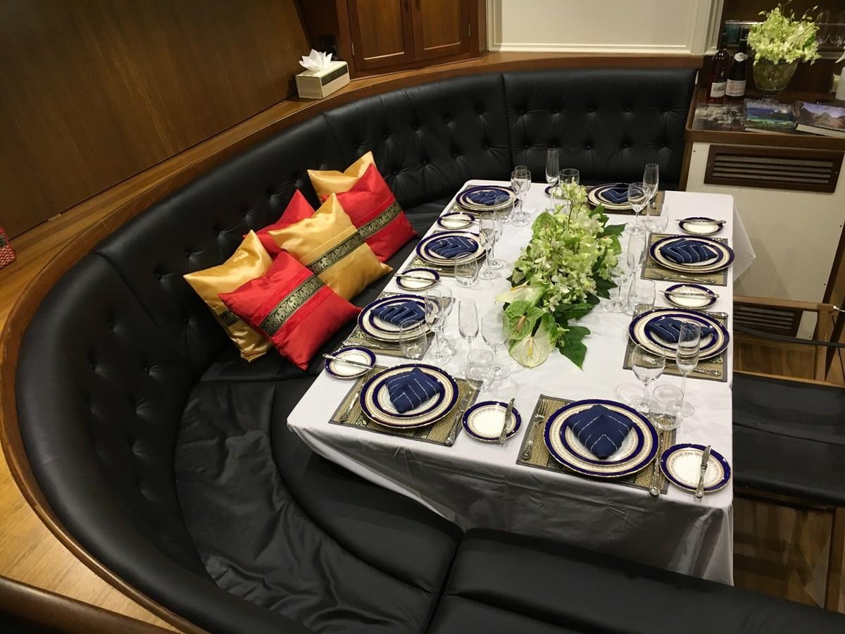 a table with plates and glasses aboard DALLINGHOO Yacht for Sale