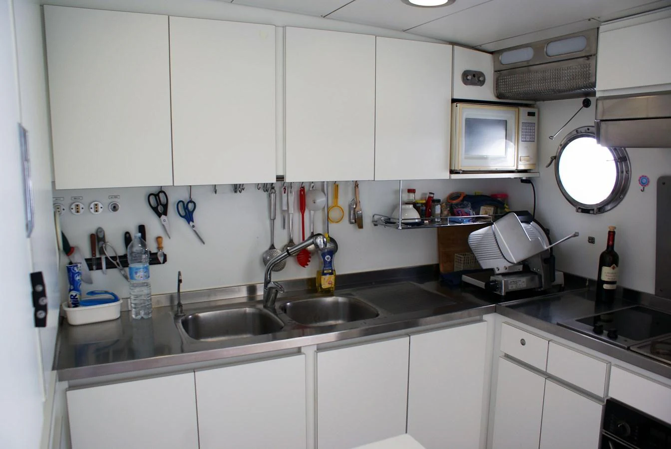 a kitchen with white cabinets aboard LUC AN Yacht for Sale
