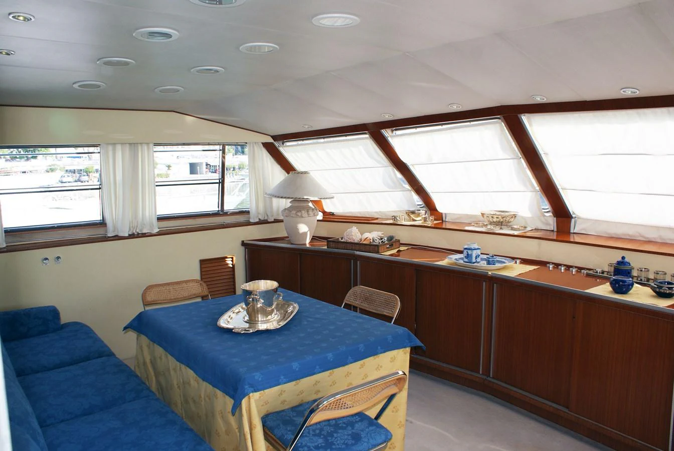 a room with a table and chairs aboard LUC AN Yacht for Sale