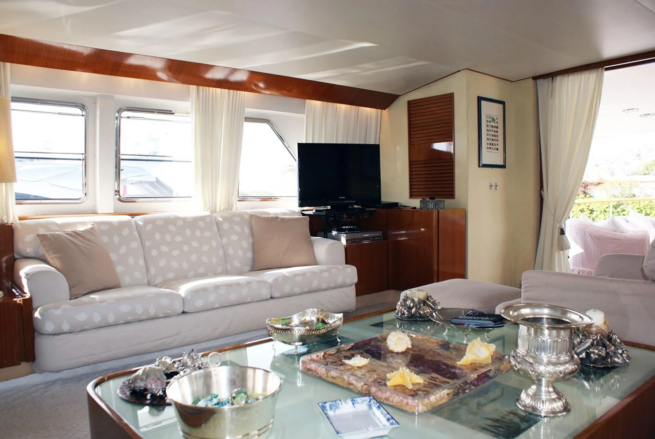 a living room with a large table and a couch aboard LUC AN Yacht for Sale