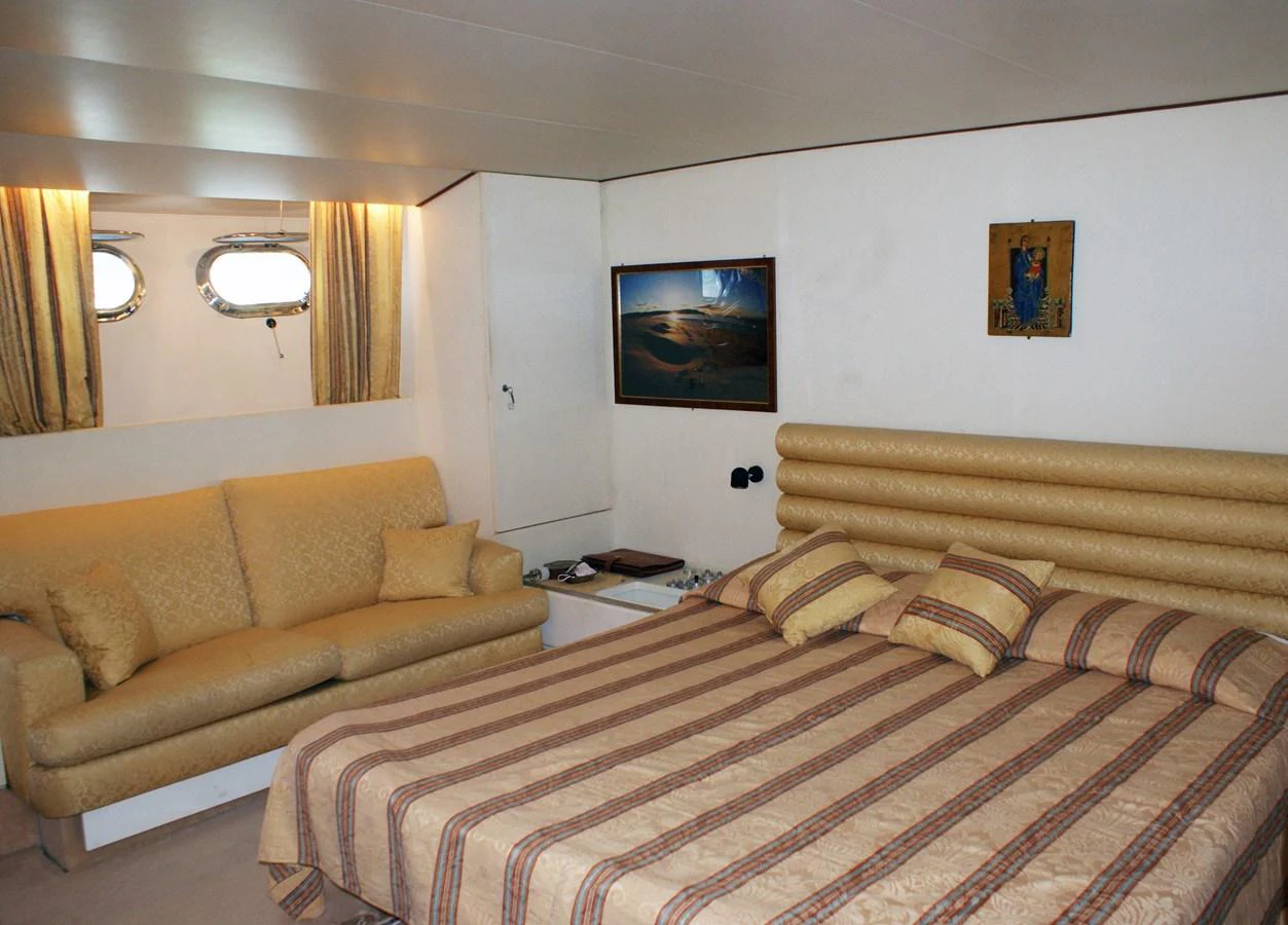 a hotel room with a bed and a couch aboard LUC AN Yacht for Sale