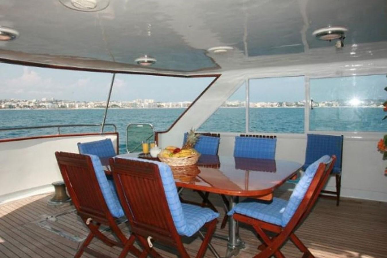 a table and chairs on a deck aboard MISS EVA Yacht for Sale