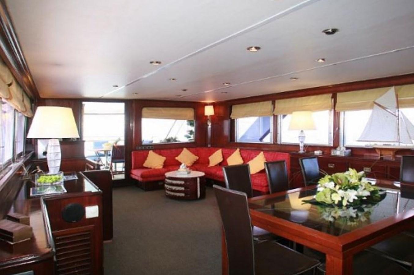 a living room with a table and chairs aboard MISS EVA Yacht for Sale