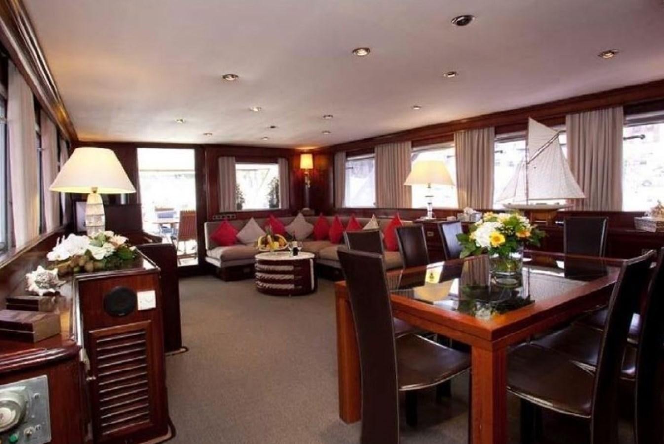 a living room with a dining table and chairs aboard MISS EVA Yacht for Sale