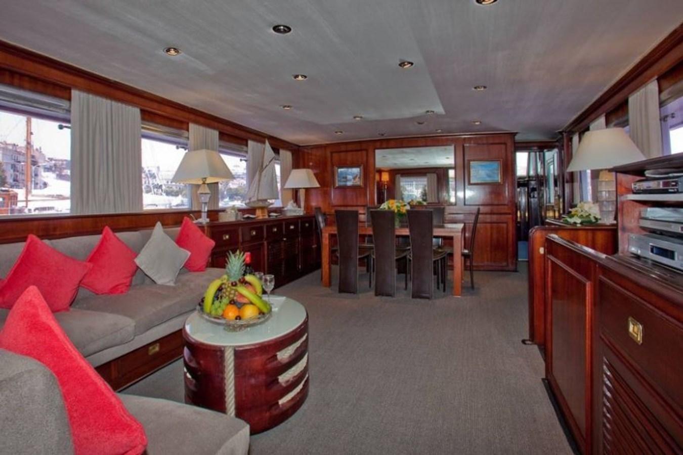 a living room with a couch and a table aboard MISS EVA Yacht for Sale